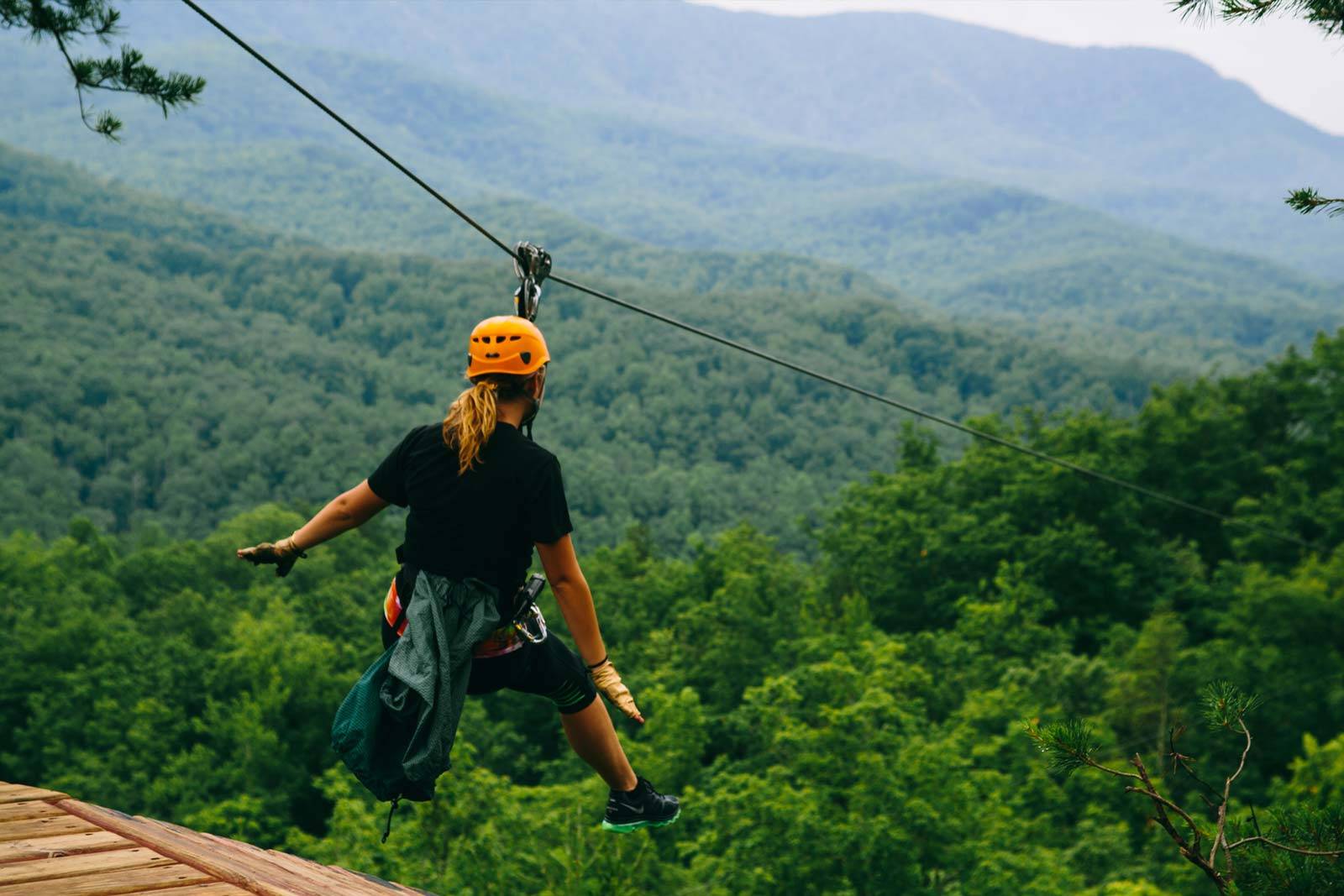 woman ziplining in smoky mountains