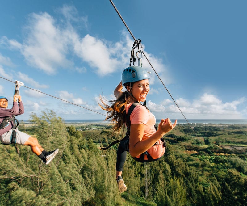 Two guests having fun at our Oahu zipline course.