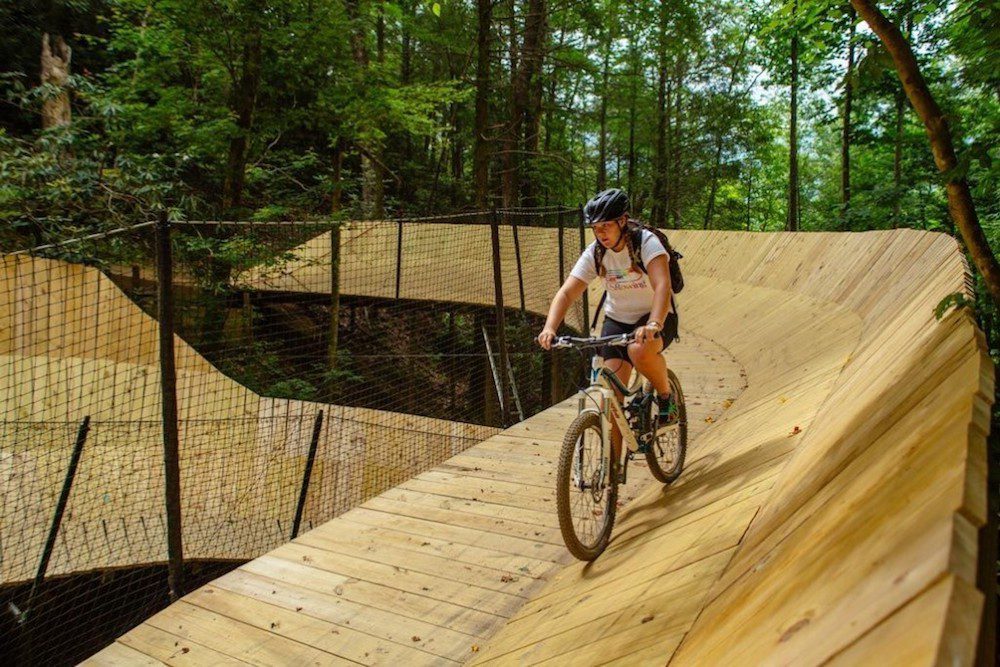 A girl mountain biking in Gatlinburg on The Curliest.