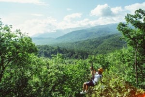 A man ziplining in the Smoky Mountains at CLIMB Works.