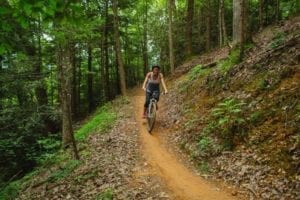 A woman mountain biking in Gatlinburg at CLIMB Works.