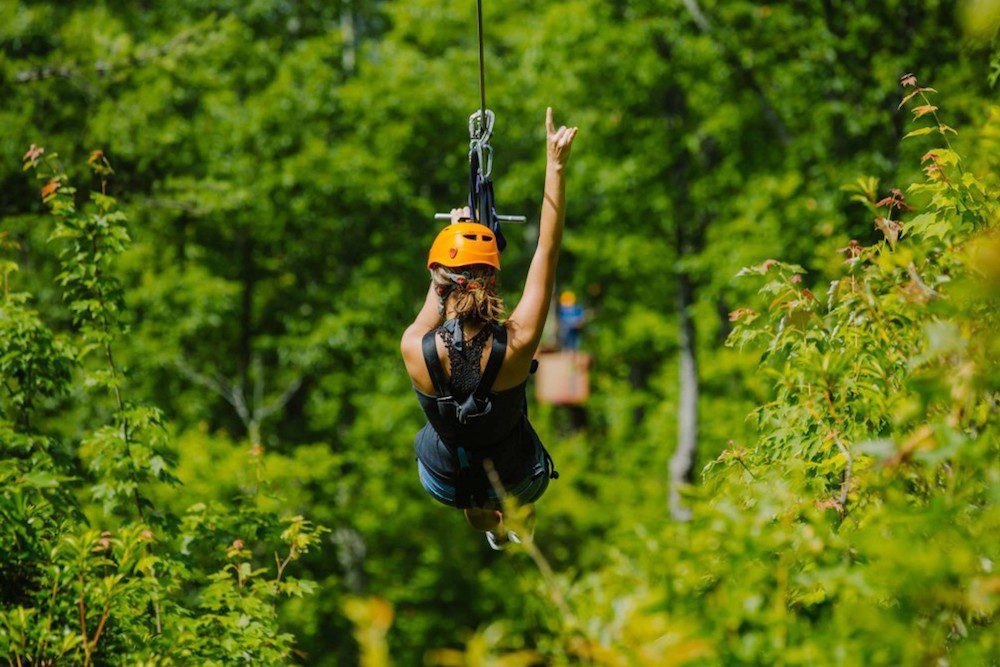 A woman riding a zipline in Gatlinburg TN.