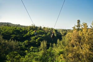 A smiling couple riding one of our Oahu ziplines.