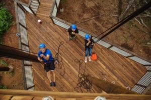 Guests pulling themselves up with ropes at our ziplines in Oahu.