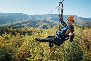 happy girl ziplining in smoky mountains