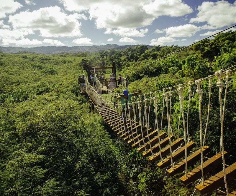 guy walking across bridge at Keana Farms