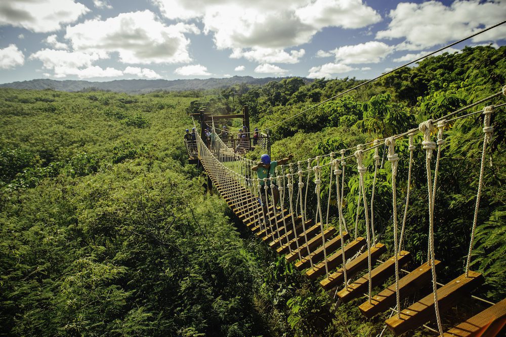 guy walking across bridge at Keana Farms