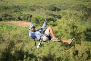 man ziplining in oahu