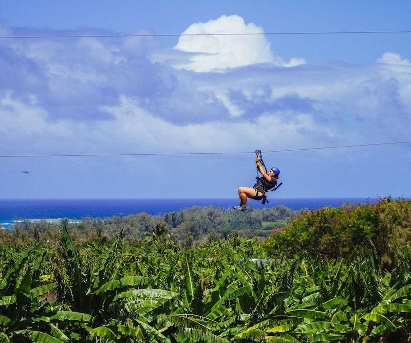 woman ziplining in oahu solo