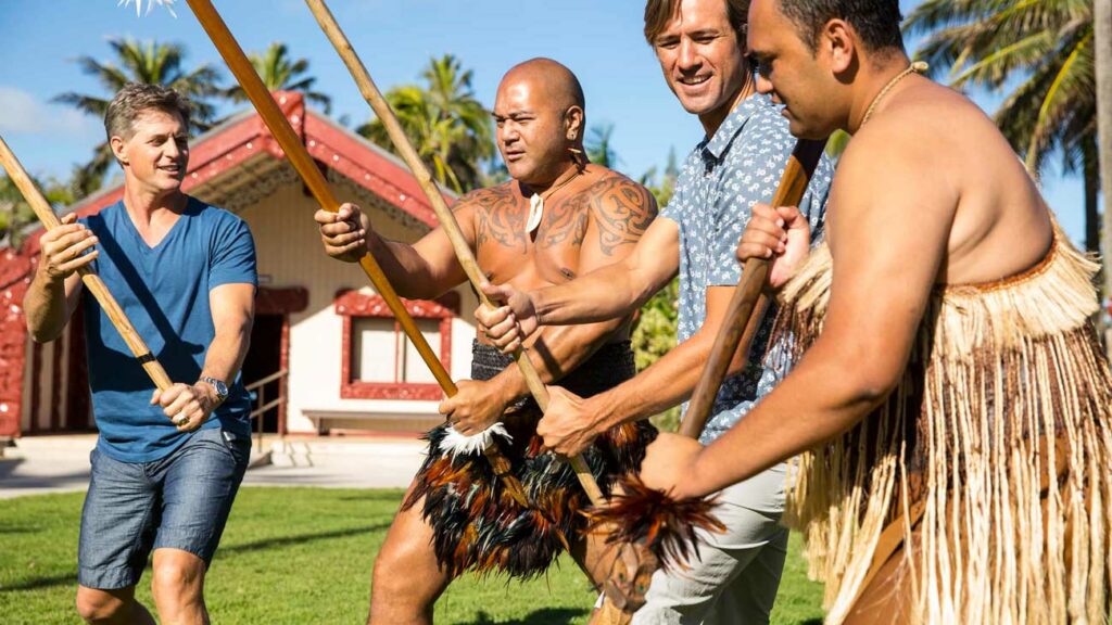 Staff teach men how to wield weapons in the Aotearoa village