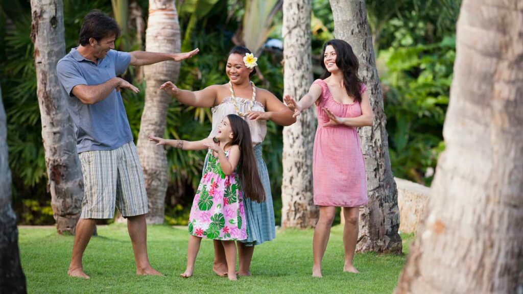 A family is taught to Hula dance by a professional dancer at the Polynesian Cultural Center