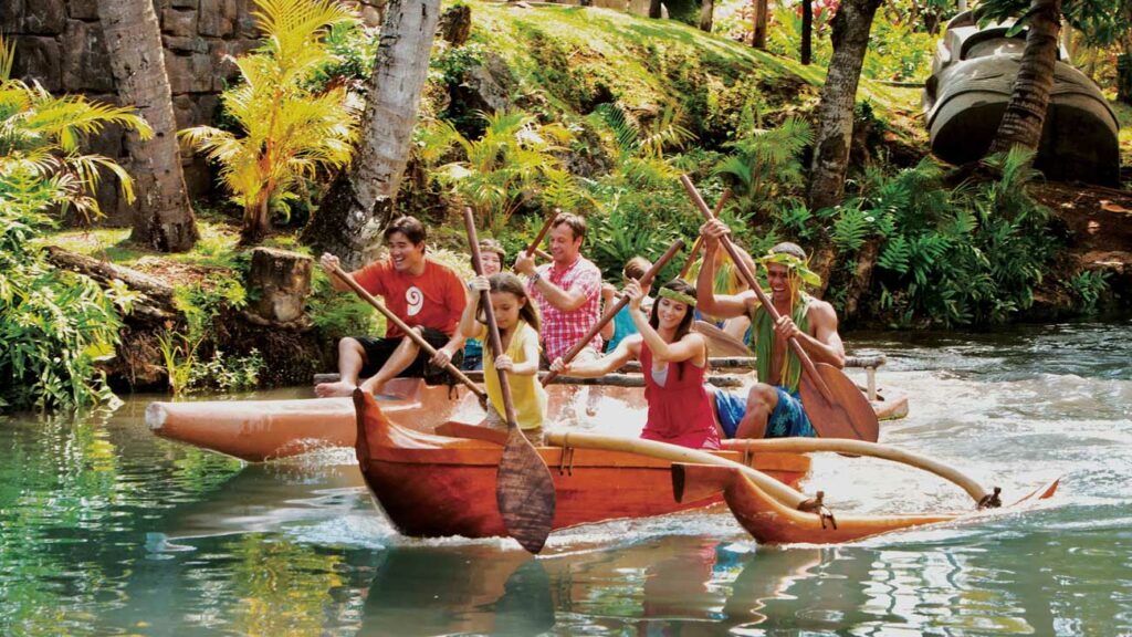 A family rows across a lagoon at the Polynesian Cultural Center on a Canoe