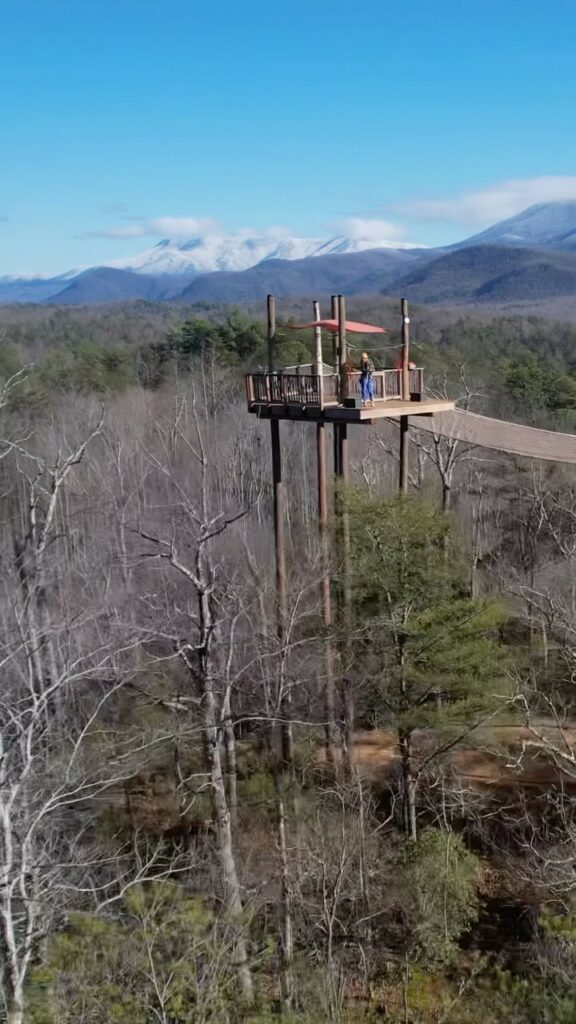 Zipline tower with attached skybridge soars high above the canopy at CLIMB Works Smoky Mountains